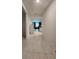 Hallway featuring tile floors leading to the living area at 1134 Pando Loop, Orlando, FL 32824