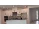 Kitchen with white cabinetry, a center island, and stainless steel appliances at 1134 Pando Loop, Orlando, FL 32824