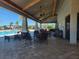 Covered pool lounge area with plenty of seating and overhead fans at 1134 Pando Loop, Orlando, FL 32824
