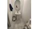 The powder room has a pedestal sink, a silver trash can and a mirror at 1134 Pando Loop, Orlando, FL 32824