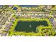 Aerial view of luxury homes surrounding a calm lake with fountain, showcasing the well-manicured lawns at 11689 Hampstead St, Windermere, FL 34786