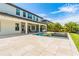 Expansive backyard featuring a modern pool, jacuzzi, outdoor kitchen, and lush landscaping at 11689 Hampstead St, Windermere, FL 34786