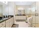 Spacious bathroom with double vanities, a walk-in shower, and neutral tile flooring at 11689 Hampstead St, Windermere, FL 34786