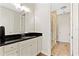Contemporary bathroom featuring white cabinetry, a black granite countertop, and a glass-enclosed shower at 11689 Hampstead St, Windermere, FL 34786