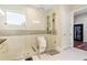 Bright bathroom featuring a glass shower and a view to a walk-in closet at 11689 Hampstead St, Windermere, FL 34786