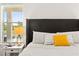 Bright bedroom featuring a large headboard and a window with a view at 11689 Hampstead St, Windermere, FL 34786