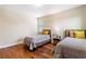Comfortable bedroom with hardwood floors, two twin beds and natural light at 11689 Hampstead St, Windermere, FL 34786