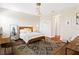 Charming bedroom features a rustic wood bed frame, brick accent wall, and stylish decorative rug at 11689 Hampstead St, Windermere, FL 34786