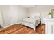 Comfortable bedroom with hardwood floors, a large white dresser, and a calming white color scheme at 11689 Hampstead St, Windermere, FL 34786