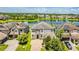 Elegant two-story home with a paver driveway, beautiful landscaping, and a tranquil lake view with fountain at 11689 Hampstead St, Windermere, FL 34786