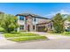 Lovely two-story home boasting a combination of stone and stucco exterior, complemented by a lush green lawn and blue sky at 11689 Hampstead St, Windermere, FL 34786