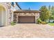 Exterior of a two-car garage with a stone facade and a brick paver driveway at 11689 Hampstead St, Windermere, FL 34786