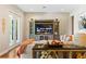 Comfortable living room featuring a large entertainment center and stylish decor at 11689 Hampstead St, Windermere, FL 34786
