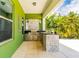 Outdoor kitchen featuring a stainless steel grill, prep area, and decorative tile backsplash at 11689 Hampstead St, Windermere, FL 34786