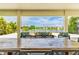 Inviting outdoor living space with a large table and comfortable seating overlooking a serene lake at 11689 Hampstead St, Windermere, FL 34786
