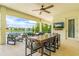 Covered outdoor patio with ceiling fan, outdoor seating, and views of the lake at 11689 Hampstead St, Windermere, FL 34786