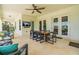 Relaxing outdoor patio offers dining area, TV, and comfortable seating with lake views at 11689 Hampstead St, Windermere, FL 34786