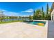Inviting pool with a water feature overlooks a serene lake and lush landscaping at 11689 Hampstead St, Windermere, FL 34786
