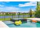 Beautiful backyard pool and spa featuring a lovely lake view and inviting water features at 11689 Hampstead St, Windermere, FL 34786