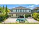 A spacious rear exterior view of this home with a beautiful pool, hot tub and outdoor kitchen at 11689 Hampstead St, Windermere, FL 34786