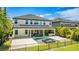 A spacious rear exterior view of this home with a beautiful pool, hot tub and outdoor kitchen at 11689 Hampstead St, Windermere, FL 34786