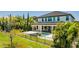 A spacious rear exterior view of this home with a beautiful pool, hot tub and outdoor kitchen at 11689 Hampstead St, Windermere, FL 34786
