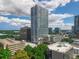 Aerial view of a modern high-rise condo building surrounded by city skyline and lush green landscape at 150 E Robinson St # 409, Orlando, FL 32801