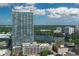Stunning aerial view of a high-rise overlooking a scenic lake and lush surroundings at 150 E Robinson St # 409, Orlando, FL 32801