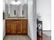 Bathroom with granite countertop vanity and wood cabinets next to doorway at 150 E Robinson St # 409, Orlando, FL 32801