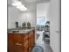 Bathroom featuring granite vanity with wood cabinets and mirrors at 150 E Robinson St # 409, Orlando, FL 32801
