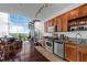 Modern kitchen with stainless steel appliances, granite countertops, and a spiral staircase to an upper level at 150 E Robinson St # 409, Orlando, FL 32801