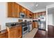 This charming kitchen features wood cabinetry, granite countertops, and stainless steel appliances at 150 E Robinson St # 409, Orlando, FL 32801