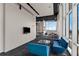 Modern lounge area with stylish blue sofas, a glass coffee table, and large windows with city views at 150 E Robinson St # 409, Orlando, FL 32801