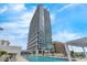 Modern condo rooftop pool with city views, white pergola, sun loungers, and blue skies at 150 E Robinson St # 409, Orlando, FL 32801