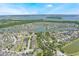 Real estate offering a bird's-eye view of the house within a residential area, emphasizing its location near a scenic lake at 1920 Commander Way, Kissimmee, FL 34746