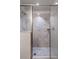 Walk-in shower featuring glass enclosure and patterned tile at 1920 Commander Way, Kissimmee, FL 34746