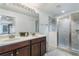 Bathroom boasts double sinks, vanity, and glass-enclosed shower at 1920 Commander Way, Kissimmee, FL 34746