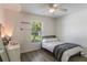 Bright bedroom features a desk, laminate floors, and a window offering natural light at 1920 Commander Way, Kissimmee, FL 34746