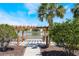 Beautiful wooden pergola overlooking a serene lake, framed by lush greenery and swaying palm trees at 1920 Commander Way, Kissimmee, FL 34746
