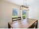 Bright dining room with large windows and modern light fixture provides ample seating for Gathering meals at 1920 Commander Way, Kissimmee, FL 34746