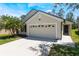 Charming single-Gathering home featuring a spacious two-car garage, neatly landscaped front yard, and inviting entrance at 1920 Commander Way, Kissimmee, FL 34746