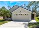 Charming single-Gathering home with a well-maintained lawn, two-car garage, and a welcoming entryway at 1920 Commander Way, Kissimmee, FL 34746
