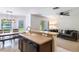 Open kitchen features a sink and bar area, seamlessly connecting to the living and dining spaces at 1920 Commander Way, Kissimmee, FL 34746