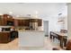 Bright kitchen with dark wood cabinets, stainless steel appliances, and a dining area at 1920 Commander Way, Kissimmee, FL 34746