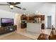 Modern kitchen with dark wood cabinets, stainless steel appliances, and an open layout to the living area at 1920 Commander Way, Kissimmee, FL 34746