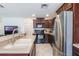 Functional kitchen with stainless steel appliances, dark wood cabinetry, and a breakfast bar at 1920 Commander Way, Kissimmee, FL 34746