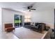 Bright living area featuring tile floors, a comfortable sofa, and access to an outdoor patio at 1920 Commander Way, Kissimmee, FL 34746