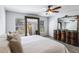 A spacious Primary bedroom featuring antique dressers, mirrors, and a ceiling fan at 1920 Commander Way, Kissimmee, FL 34746