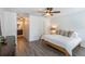 Spacious Primary bedroom with wood-look floors, ensuite bathroom, and a walk-in closet at 1920 Commander Way, Kissimmee, FL 34746