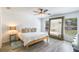 Bright bedroom with large mirror, ceiling fan, and serene view through the window at 1920 Commander Way, Kissimmee, FL 34746